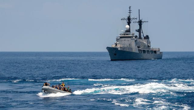 U.S. Navy sailors return to the guided-missile destroyer USS Preble (DDG-88) in a rigid-hulled inflatable boat near the Philippine Navy offshore patrol vessel Ramon Alcaraz (the former U.S. Coast Guard cutter Dallas) during Exercise Balikatan.