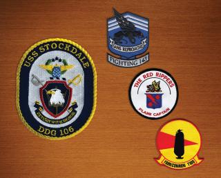 Consider designing emblematics for sale in your command store that are infused with your command’s rich history. Above are command patches from the USS Stockdale, Strike Fighter Squadron 11 (VFA-11), VFA-143, and Fleet Air Reconnaissance Squadron 2.