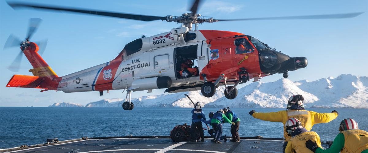 An MH-60T Jayhawk hovers over the flight deck of the USCGC Alex Haley (WMEC-39) while training for vertical replenishment in the Bering Sea.