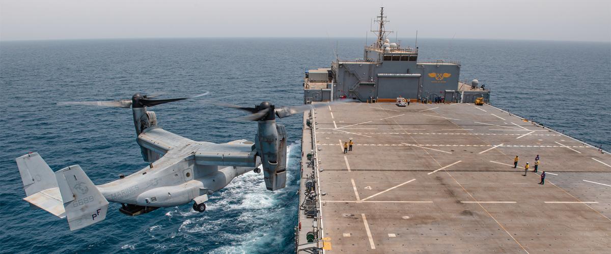An MV-22 Osprey prepares to land on board the expeditionary sea base USS Lewis B. Puller (ESB-3) in the Persian Gulf. The ESBs have expansive flight decks and the capacity to deliver several hundred Marines and their associated cargo and weapons at transoceanic distances. 