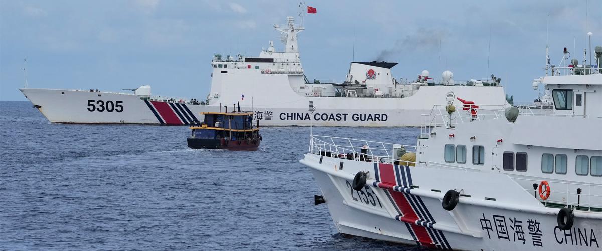 China Coast Guard ships block a Philippine supply boat the near Second Thomas Shoal in the South China Sea. Initiatives like Project Myoushu help counter China’s gray zone tactics. 