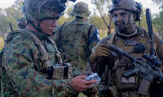 Marines of Battalion Landing Team 2/1, 31st Marine Expeditionary Unit, inspect gear with the Amphibious Rapid Deployment Regiment, Japan Ground Self-Defense Force, at Midge Point, Australia, during Exercise Talisman Sabre 23. Expanded education on adversary culture and doctrine would better prepare NCOs to adapt to complicated environments.