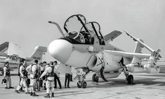 Ground-to-ground left front view of an EA-6B Prowler with crew standing outside